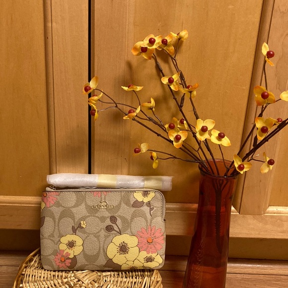 Coach of Course! Handbags - Coach Wristlet In sig. canvas w/floral cluster print.Gold/ light/ khaki multi.